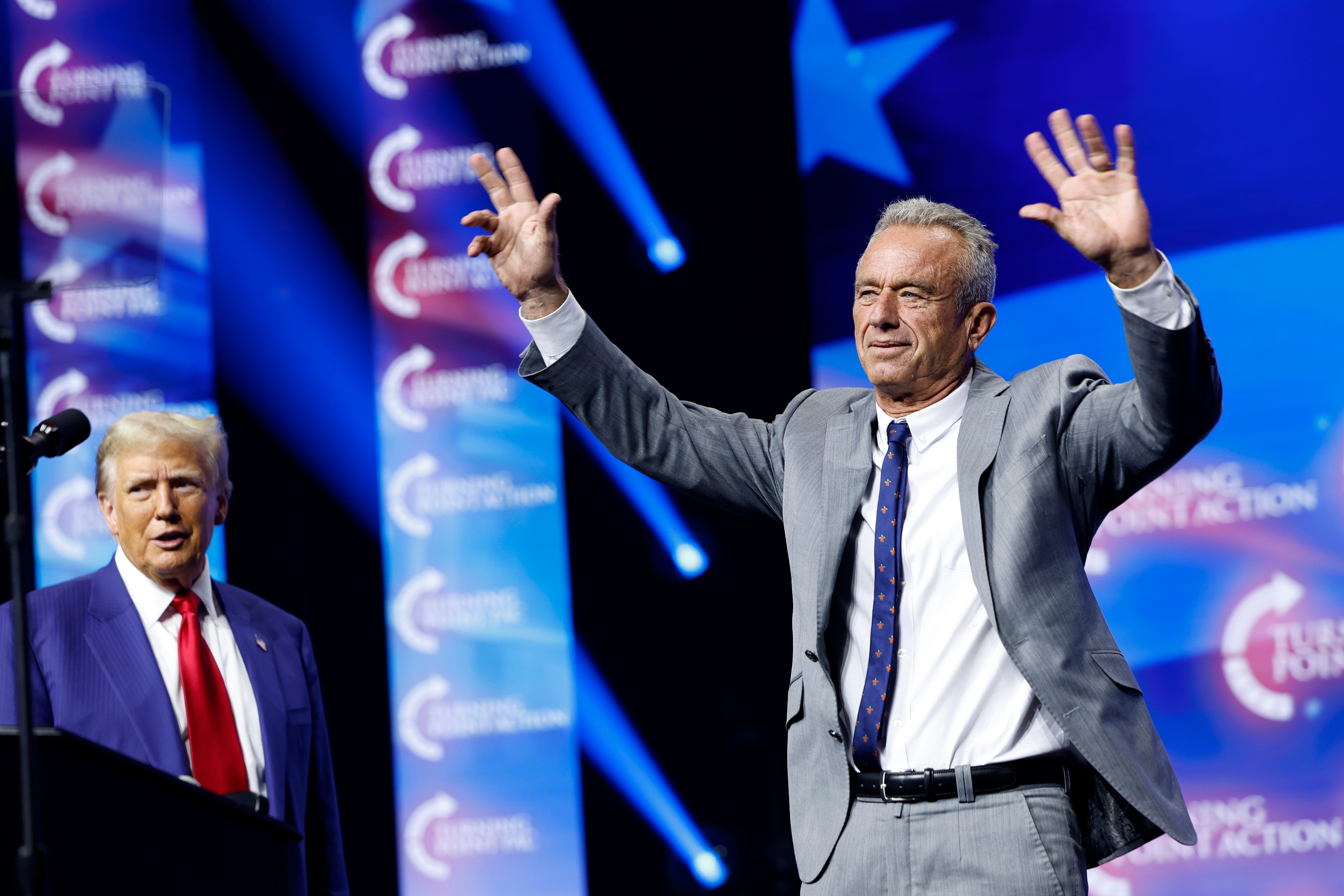 Trump shakes hands with RFK Jr during a rally in Duluth, Georgia, on October 23, 2024.