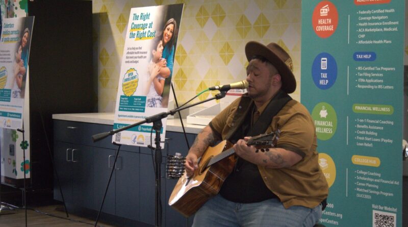 Health Alliance for Austin Musicians member Raul Adrian Ochoa played the guitar at an event at Foundations Communities for Affordable Care Act enrollment. (Elisabeth Jimenez/Community Impact)